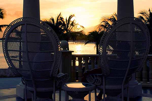 silhouette of 2 chairs with the sun as a backdrop thumbnail