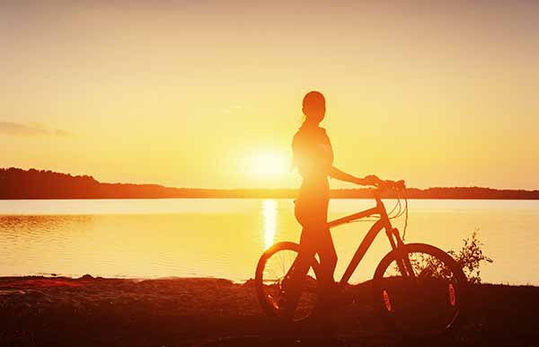 boy on a bicycle at sunset