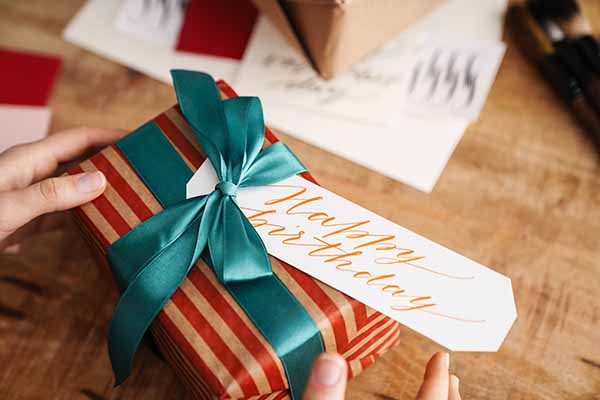 calligrapher girl working on birthday present