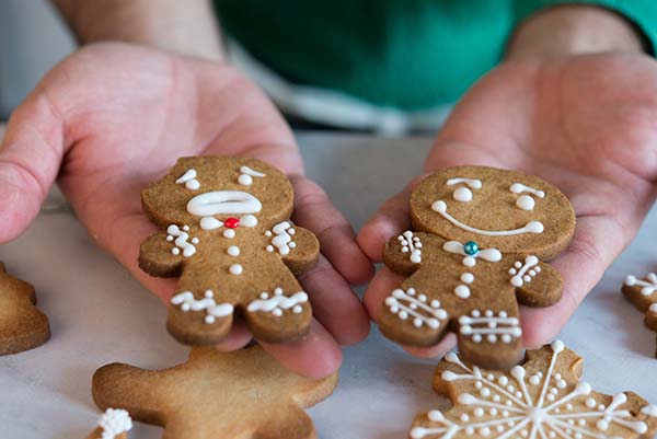 hands holding two different gingerbread men