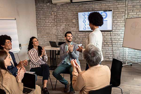 group of people applauding speaker standing up