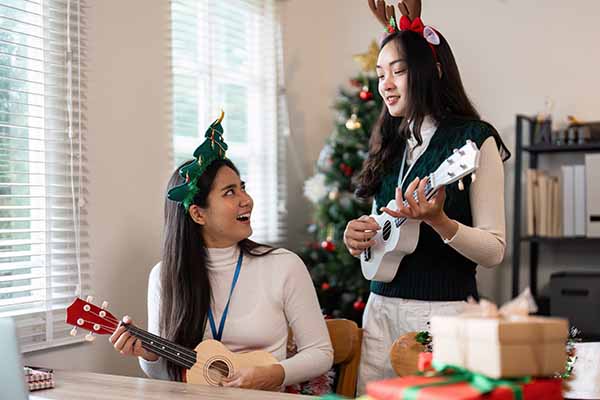 festive holiday gathering with friends playing ukulele